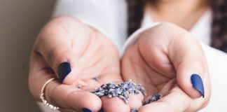 Blue Nail Designs for 2022-2023 two hands of a girl with blue nails