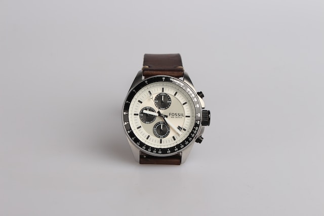 watches with leather band on white surface