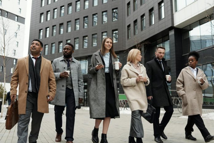 Coworkers Taking a Coffee Break and Walking