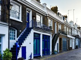 Can You Get a Magazine-Worthy Front Door Without Breaking the Bank? a-row-of-brick-buildings-with-blue-doors