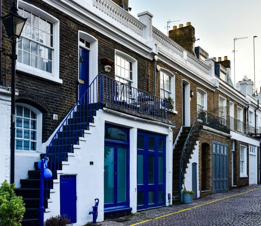 a-row-of-brick-buildings-with-blue-doors