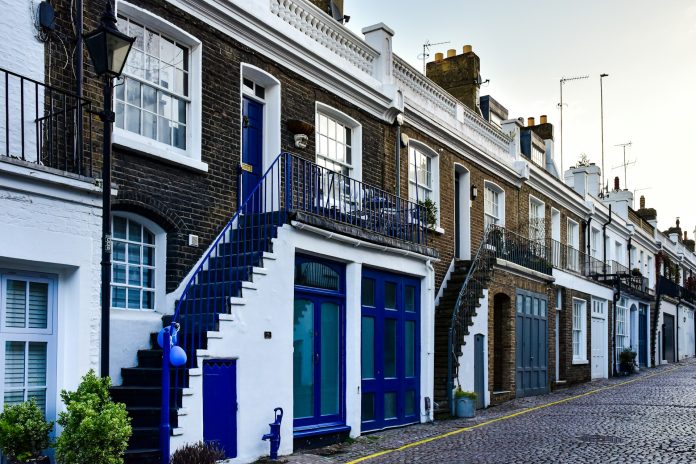 a-row-of-brick-buildings-with-blue-doors