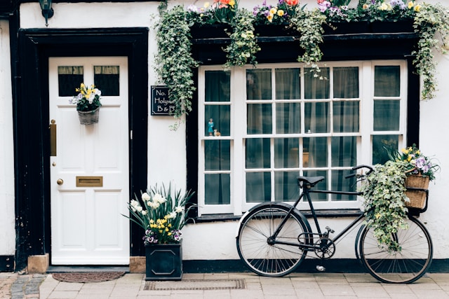 black-fixie-bike-near-white-wooden-door