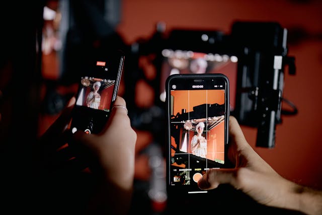 hands-holding-smartphones-and-recording-videos-of-model